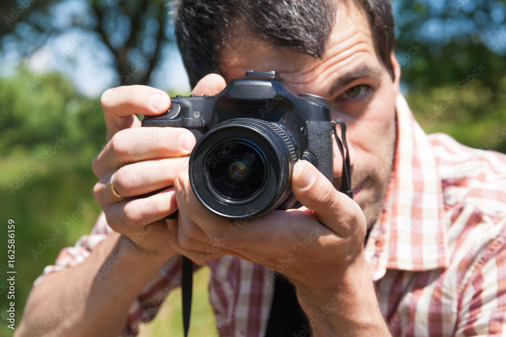 Man photographer with camera in nature Man photographer with camera in nature