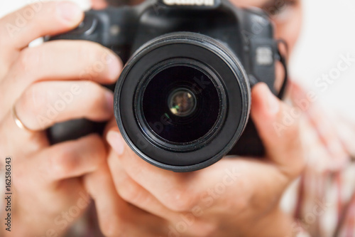 Man photograph with camera in hand