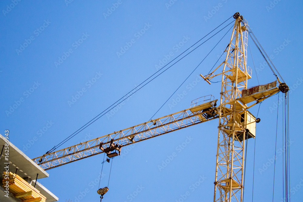 A crane near the building under construction. Novosibirsk, Russia, June 2017.