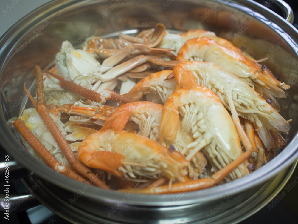 Shrimp and Crab cooked by steam in stainless steel steamer pot Shrimp and Crab cooked by steam in stainless steel steamer pot