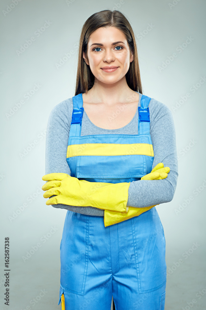 Smiling woman builder wearing overalls standing with crossed arms. Smiling woman builder wearing overalls standing with crossed arms.