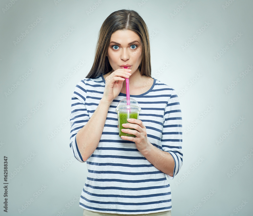 Young woman drinking smoothie drink. Young woman drinking smoothie drink.