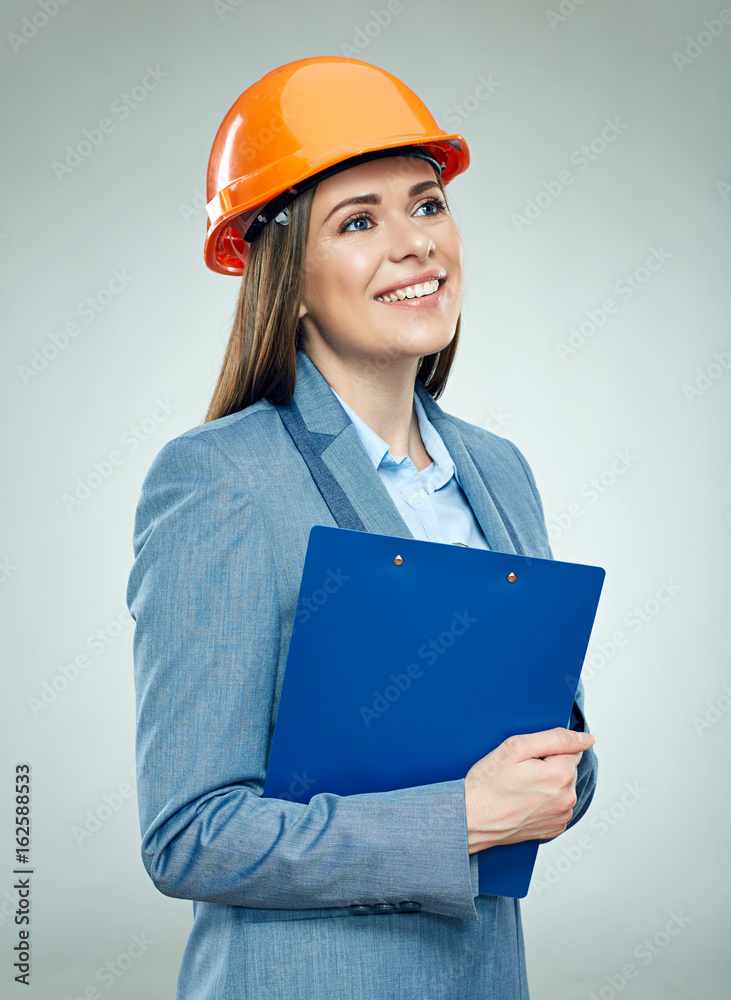 Smiling business woman builder holding clipboard. Smiling business woman builder holding clipboard.