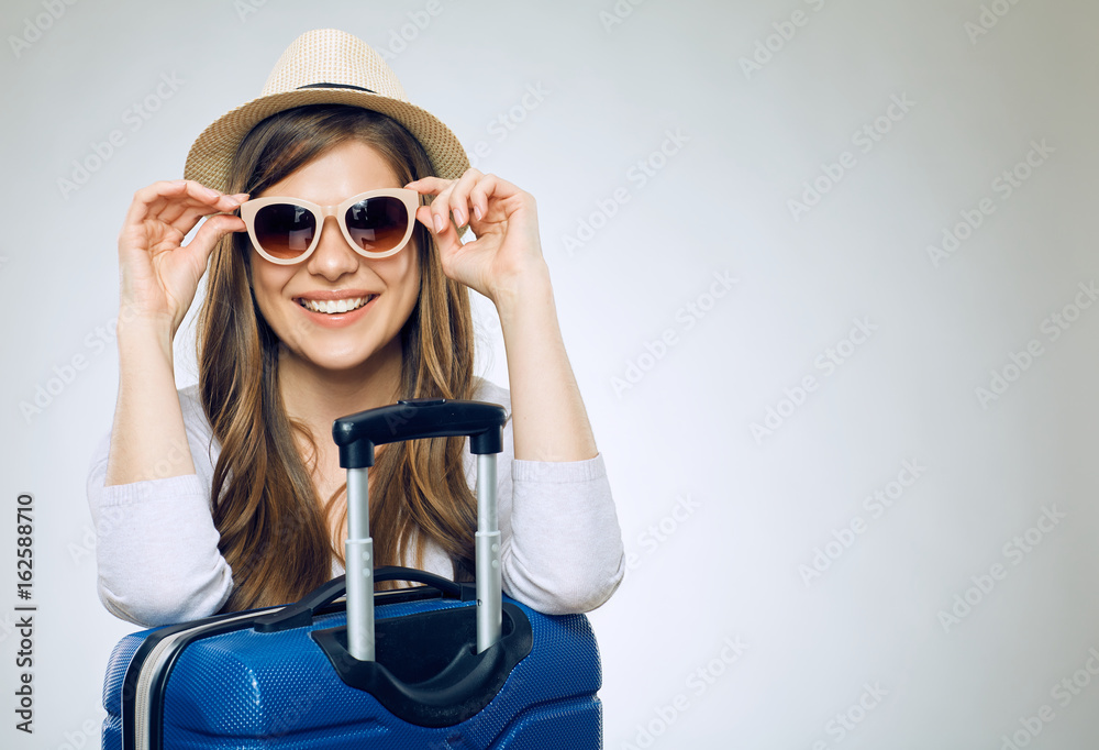 Smiling woman wearing sun glasses and hat