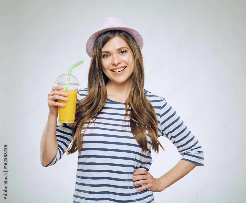 Young smiling woman holding orange juice glass. Young smiling woman holding orange juice glass.