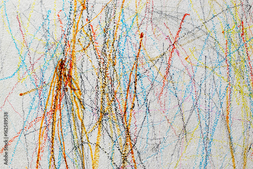 Drawing with colored pencil on the wall of a child.
