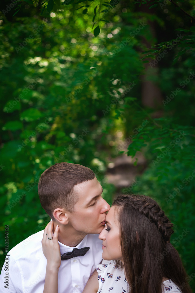 couple kissing in forest couple kissing in forest