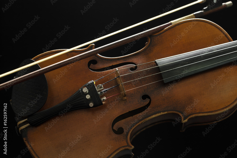 Fototapeta premium Old violin on a black background