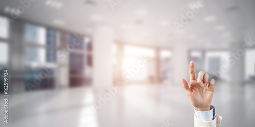 Choosing gesture of businessperson in elegant modern interior in