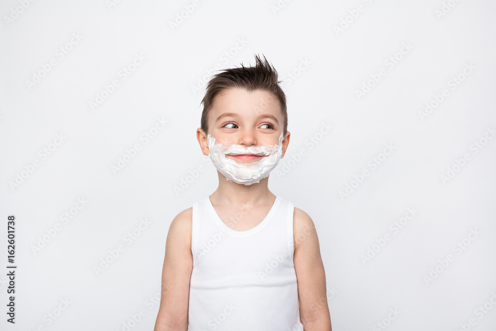 Boy with shaving foam on face