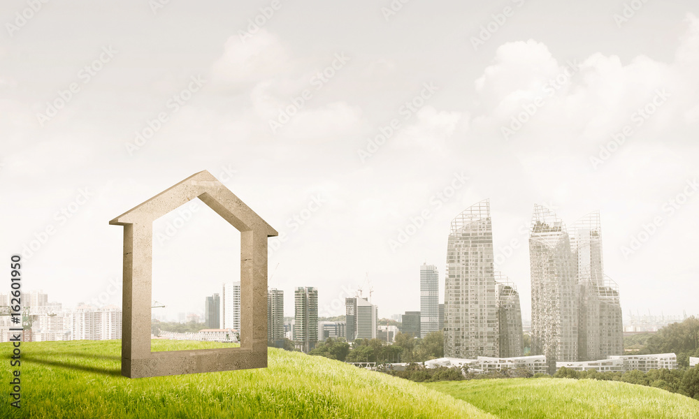 Conceptual image of concrete home sign on hill and natural lands Conceptual image of concrete home sign on hill and natural lands