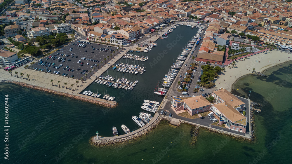Aerial top view of boats and yachts in marina from above, harbor of Meze town, South France
