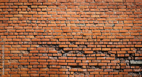 destroyed wall red brick background