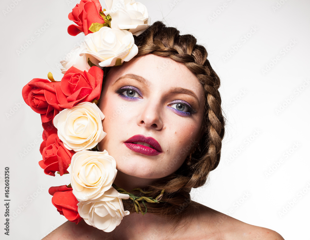 Gorgeous Woman with flowers arround her head in studio photo. Beauty and fashion. Glamour and summer