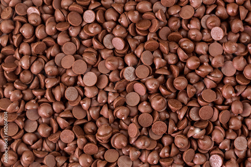 Texture of small chunks of sweetened chocolate chips background