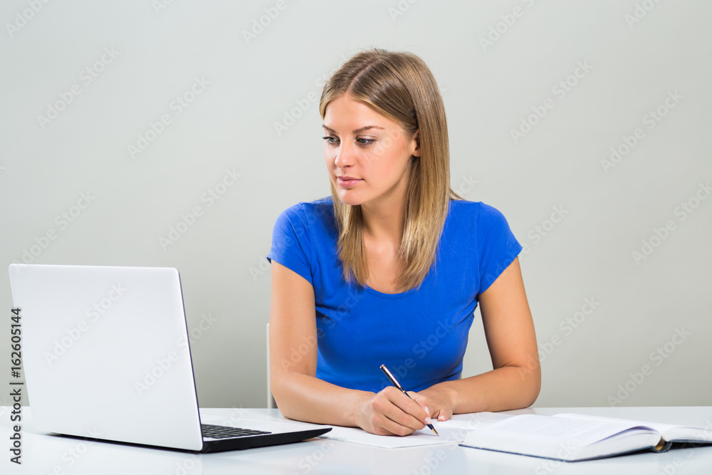 Beautiful female student using laptop and studying. Beautiful female student using laptop and studying.