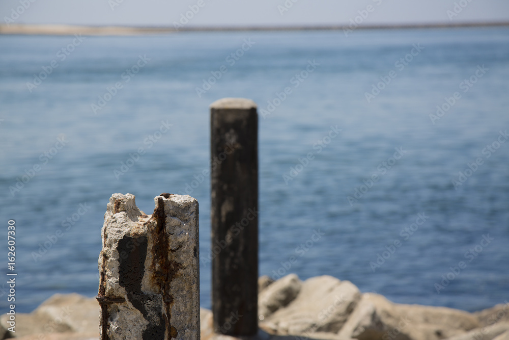 Old rusty concrete pole on a pier Old rusty concrete pole on a pier