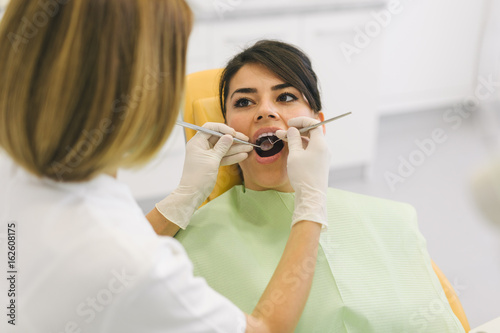 Woman repairing teeth at the dentist office