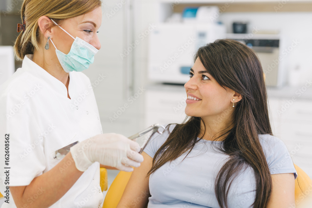 Tooth extraction. Dentist and patient at the dental office. Tooth extraction. Dentist and patient at the dental office.