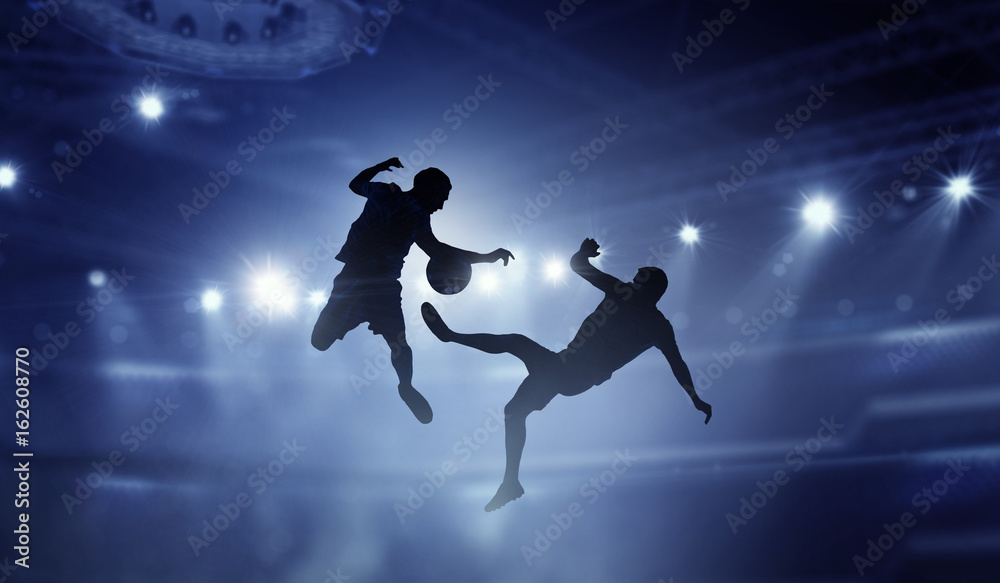 Silhouettes of two soccer players . Mixed media