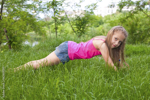 Young girl doing sports exercises - plank