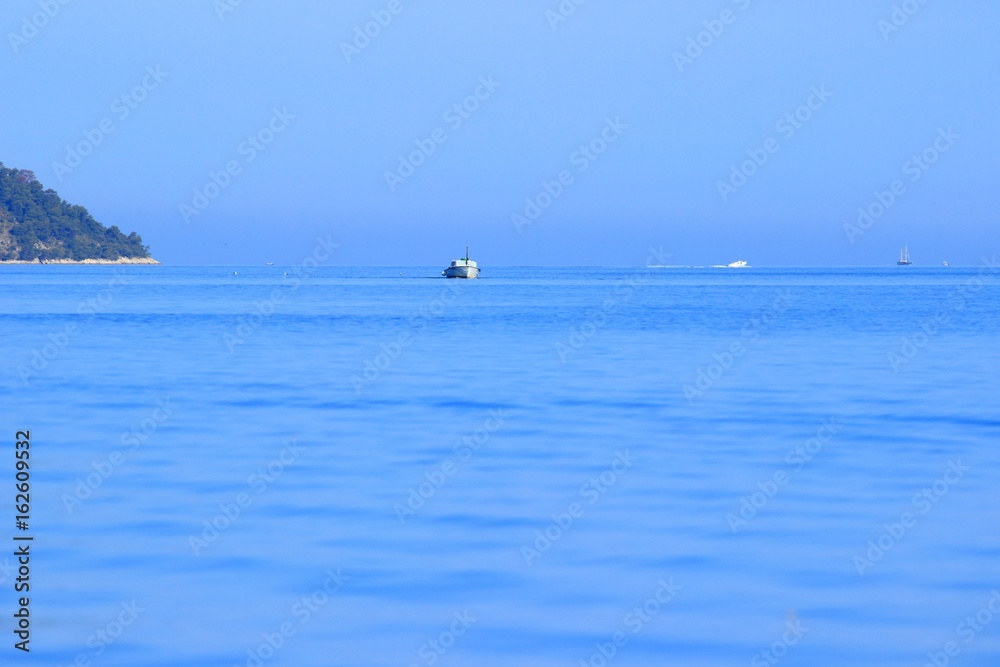 Ships and boats in calm sea, morning light