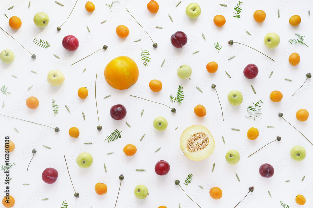 Fruity pattern. Fruits, plants and flowers on a white background. Food background. Top view. Fruity pattern. Fruits, plants and flowers on a white background. Food background. Top view.