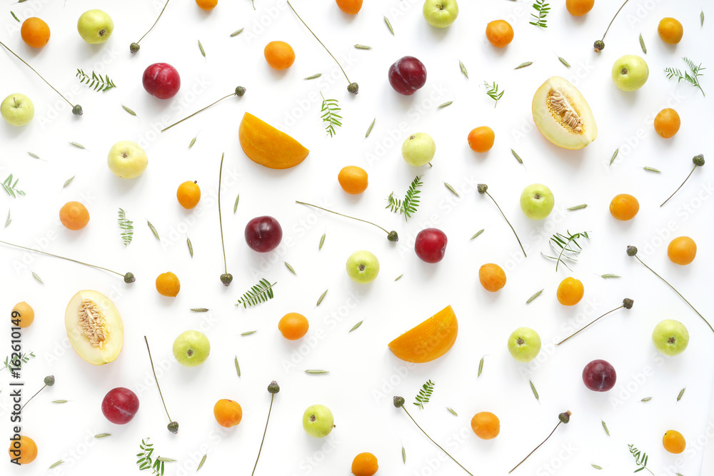 Fruity pattern. Fruits, plants and flowers on a white background. Food background. Top view. Fruity pattern. Fruits, plants and flowers on a white background. Food background. Top view.