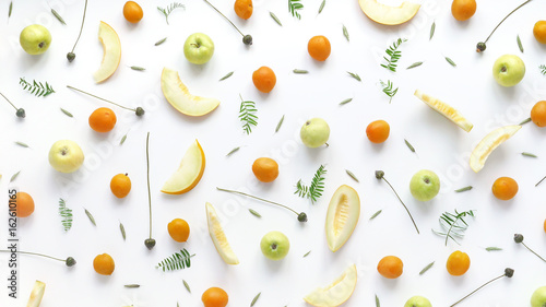 Fruity pattern. Fruits, plants and flowers on a white background. Food background. Top view.