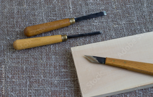 Tools for woodcarving. Close-up on a background of sackcloth