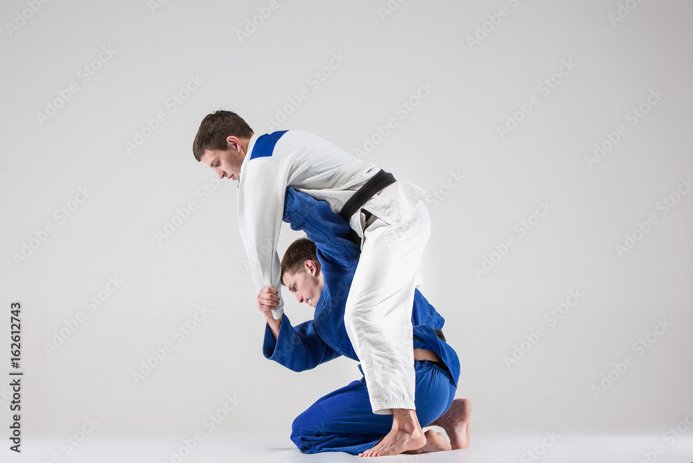 The two judokas fighters fighting men The two judokas fighters fighting men