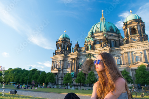 Photography Pretty gil sitting in front of Berlin Cathedral wearing sunglusses