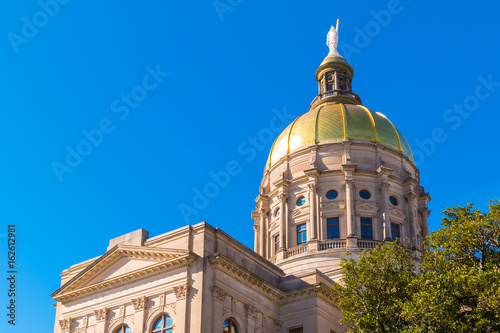 Bottom view of the tholobate and the dome of Georgia State Capitol on the background of clear sky, Atlanta, USA