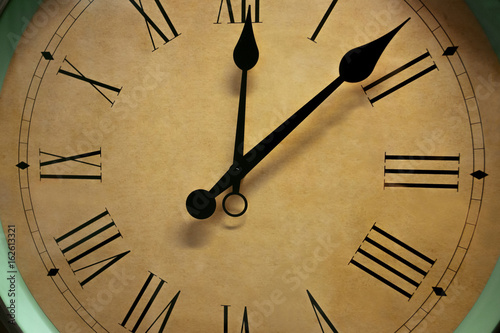 Closeup of vintage Wall clock. Retro roman numeral wall clock.