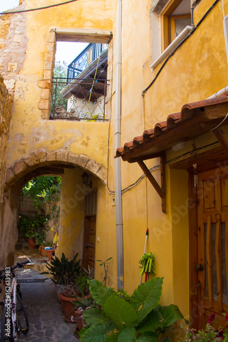 Fototapeta Naklejka Na Ścianę i Meble -  Yellow yard on street in greek town Chania. Crete