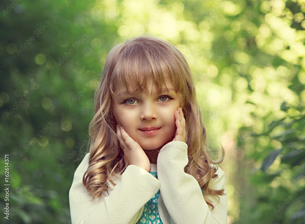 Portrait of a beautiful little blonde girl with green balloon in the park at the sunny summer day. Portrait of a beautiful little blonde girl with green balloon in the park at the sunny summer day.