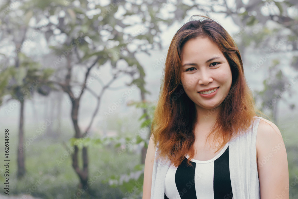 Portrait of a beautiful happy girl on the park and fog in the morning Portrait of a beautiful happy girl on the park and fog in the morning