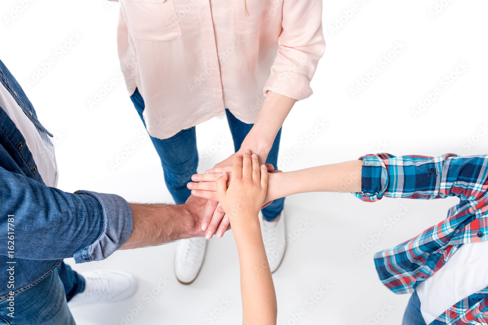 top view of family making pile of hands isolated on white top view of family making pile of hands isolated on white