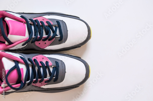 Top view of sneakers on white background. Fitness wear and equipment. Sport fashion, Sport accessories, Sport equipment.Healthy concept copy Space