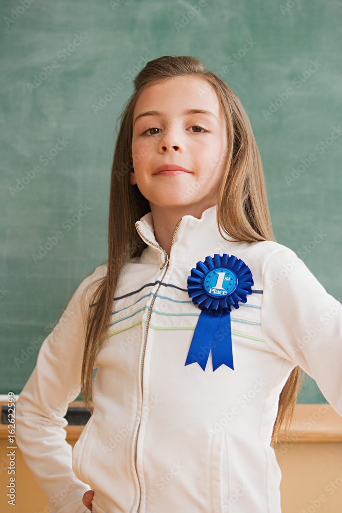 Fotografie Schoolgirl wearing a rosette
