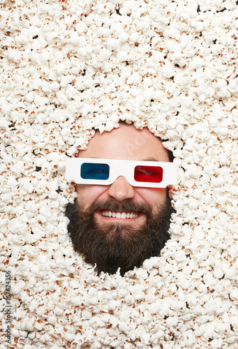 Bearded man in stereoglasses and popcorn photo