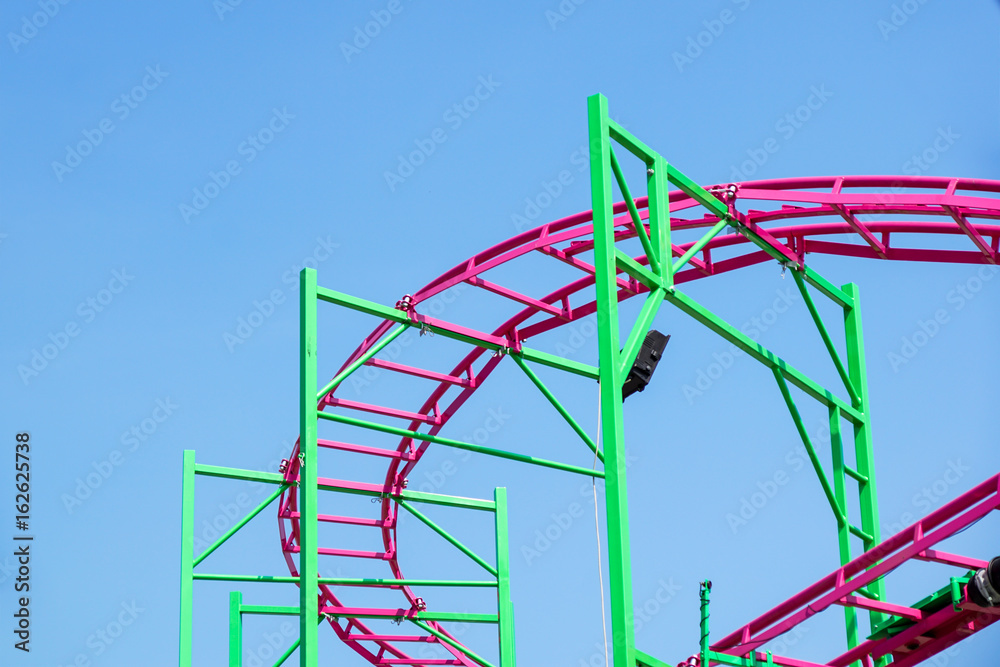 Rollercoaster track rail against a brilliant blue sky Rollercoaster track rail against a brilliant blue sky