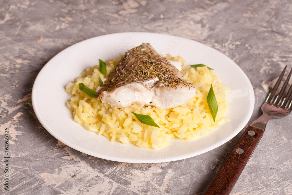 fish with rice on a white plate fish with rice on a white plate