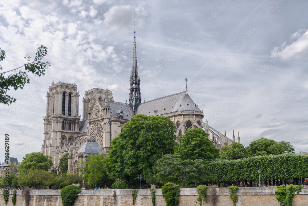 Paris, Notre-Dame cathedral in the ile de la Cite, cloudy sky Paris, Notre-Dame cathedral in the ile de la Cite, cloudy sky