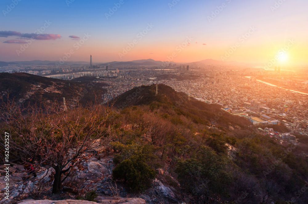 Seoul City and skyline with skyscrapers in Sunset, Han river in Aerial view of Yongma Mountain or Yongmasan, South Korea.