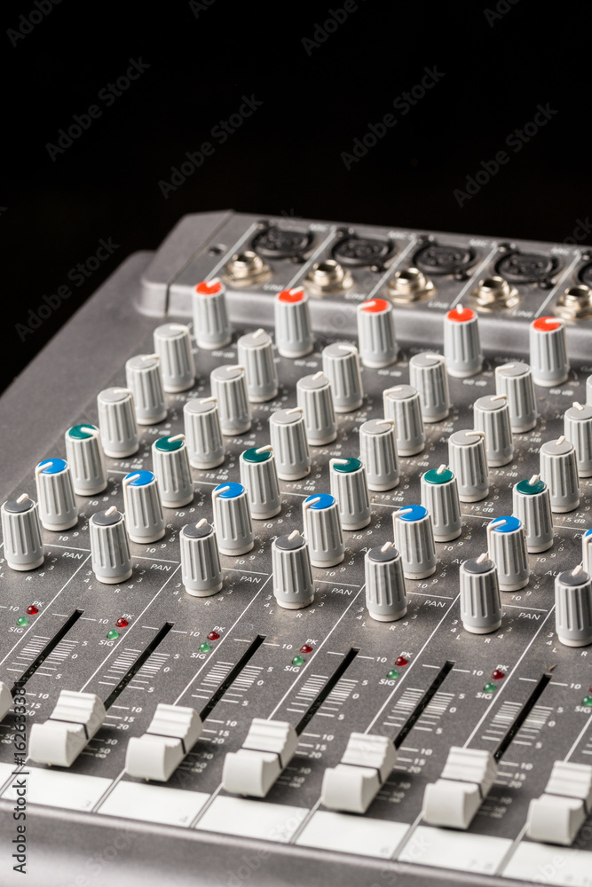 Fototapeta premium Audio mixing console with sliders and knobs on the channels.