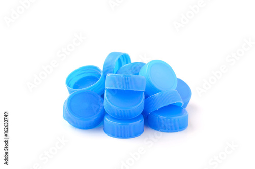 pile of blue plastic bottle cap on white background