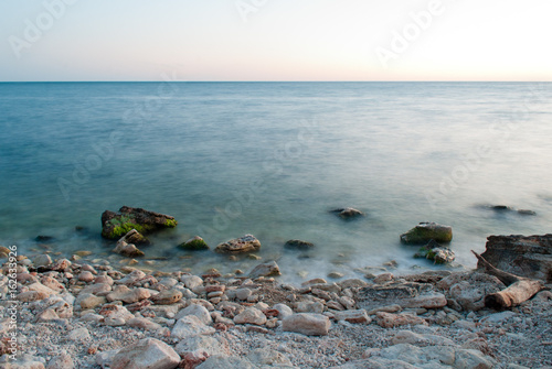Beautiful sunset over the sea and rocky shore © Gennadiy