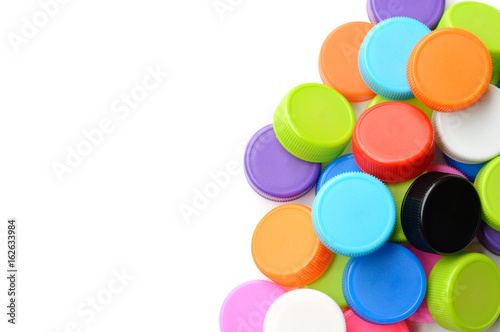 pile of colorful plastic bottle cap on white background