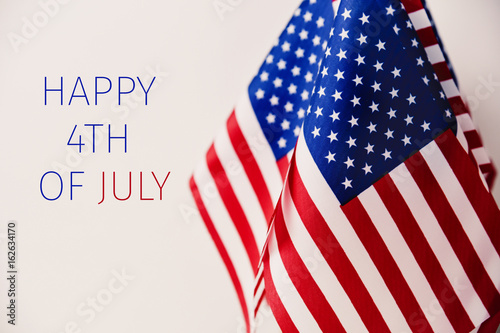 text happy 4th of july and american flags